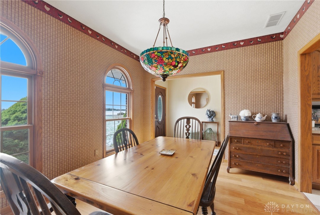 1540 Jasper Road Xenia, OH 45385 - Photo 24 of 91 This inviting dining area features elegant arch-top windows, creating a bright and airy atmosphere.