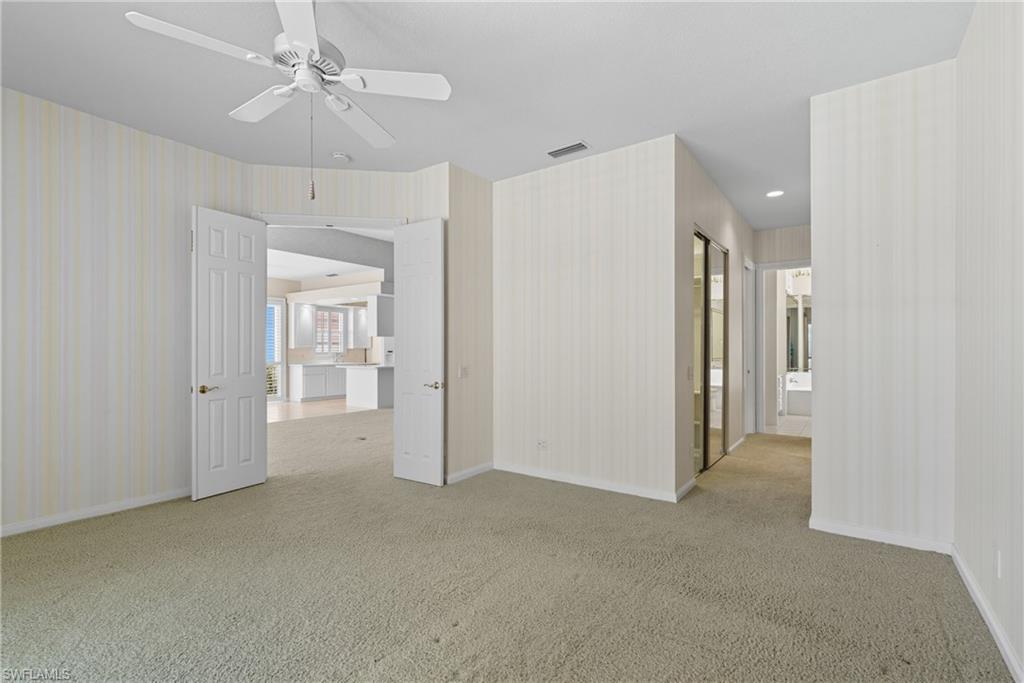 5925 Bermuda Lane Naples, FL 34119 - Photo 13 of 24 Spare room with light carpet and a ceiling fan