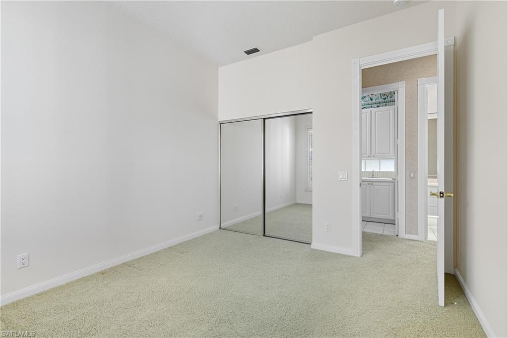 5925 Bermuda Lane Naples, FL 34119 - Photo 18 of 24 Unfurnished bedroom with light carpet and a closet