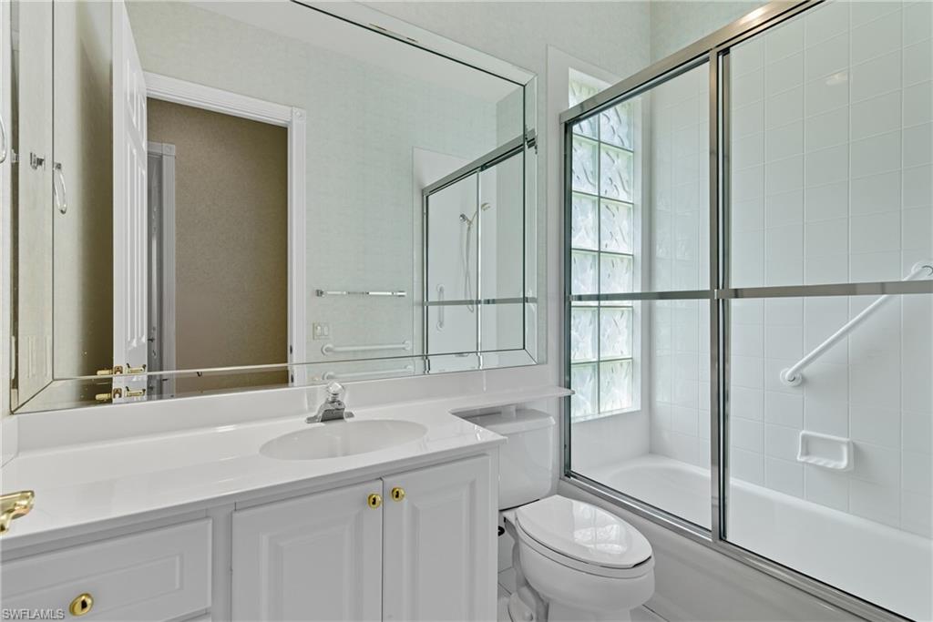 5925 Bermuda Lane Naples, FL 34119 - Photo 20 of 24 Bathroom with enclosed tub / shower combo, vanity, and plenty of natural light