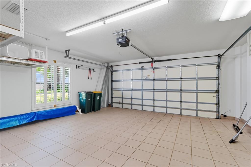 5925 Bermuda Lane Naples, FL 34119 - Photo 21 of 24 Garage featuring a garage door opener and french doors