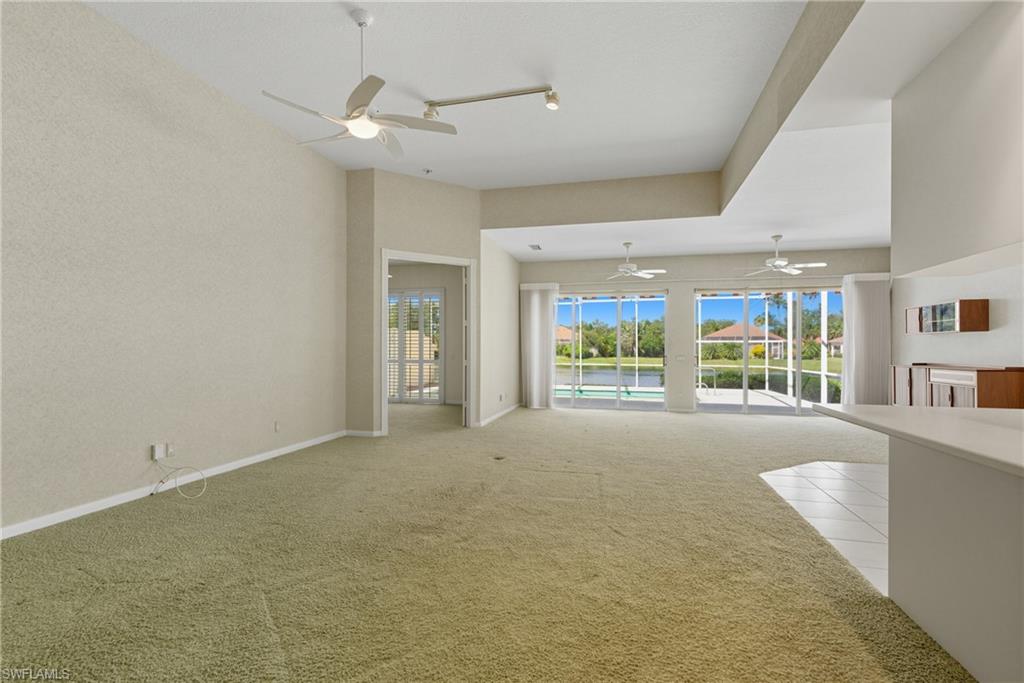 5925 Bermuda Lane Naples, FL 34119 - Photo 3 of 24 Unfurnished living room featuring carpet floors and ceiling fan