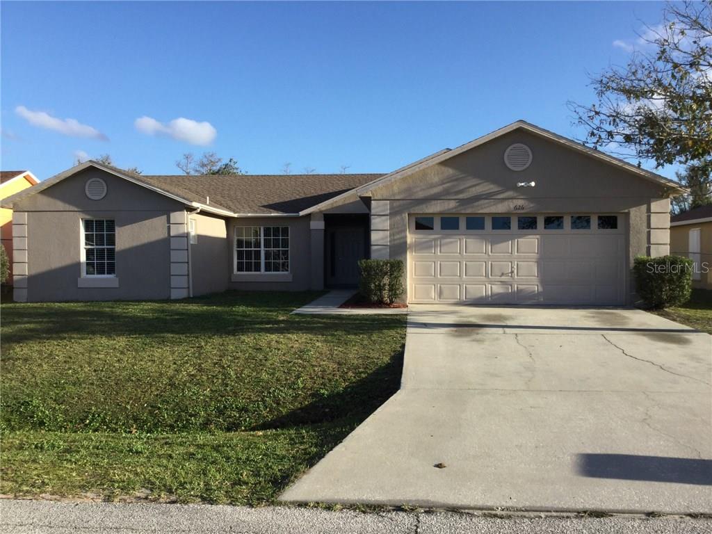 626 Regency Way Kissimmee, FL 34758 - Photo 1 of 1 a front view of a house with a garden