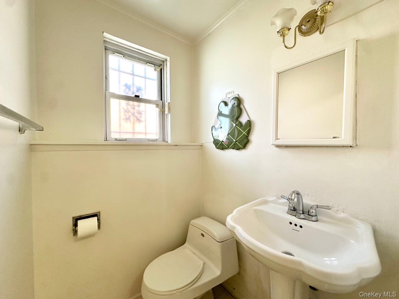 28-30 210th Street Queens, NY 11360 - Photo 16 of 19 Half bath featuring toilet and crown molding