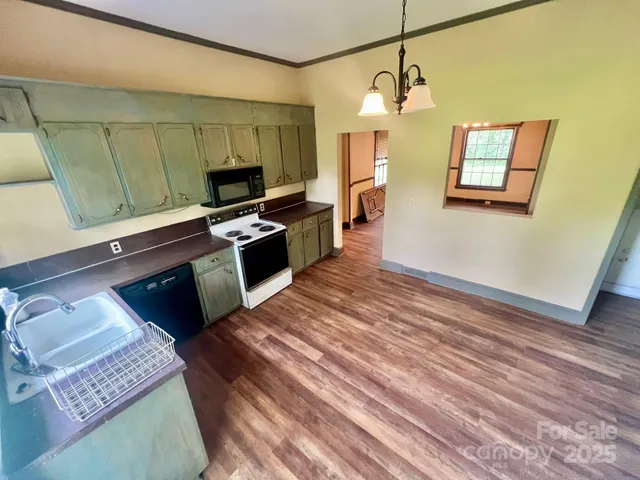 a kitchen with granite countertop a stove and a sink