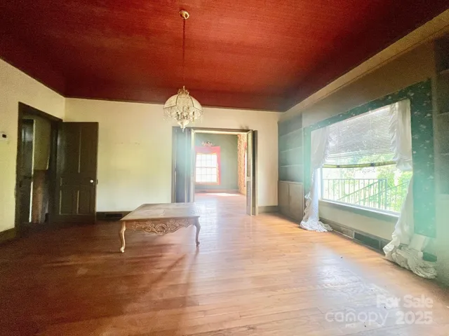 a view of a room with window and wooden floor