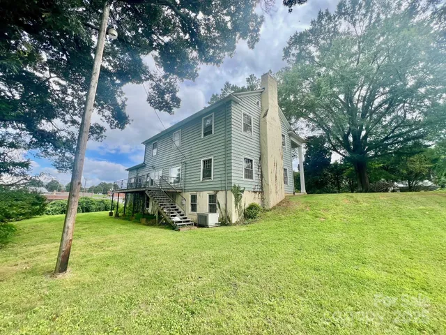 a view of a house with backyard porch and sitting area