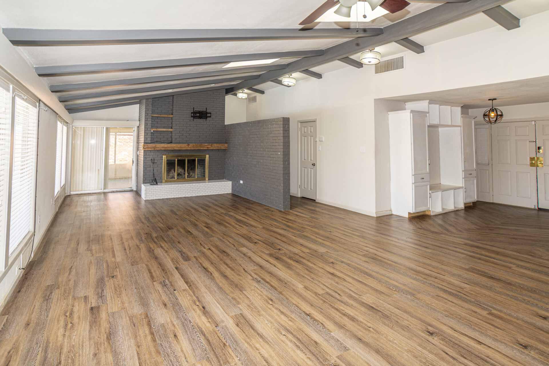 2136 57th Street Lubbock, TX 79412 - Photo 2 of 41 a view of a room with wooden floor fireplace and windows