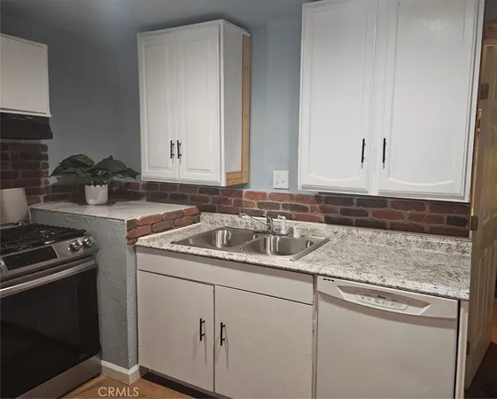 a kitchen with a sink stove and cabinets