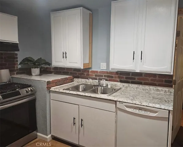a kitchen with a sink stove and cabinets