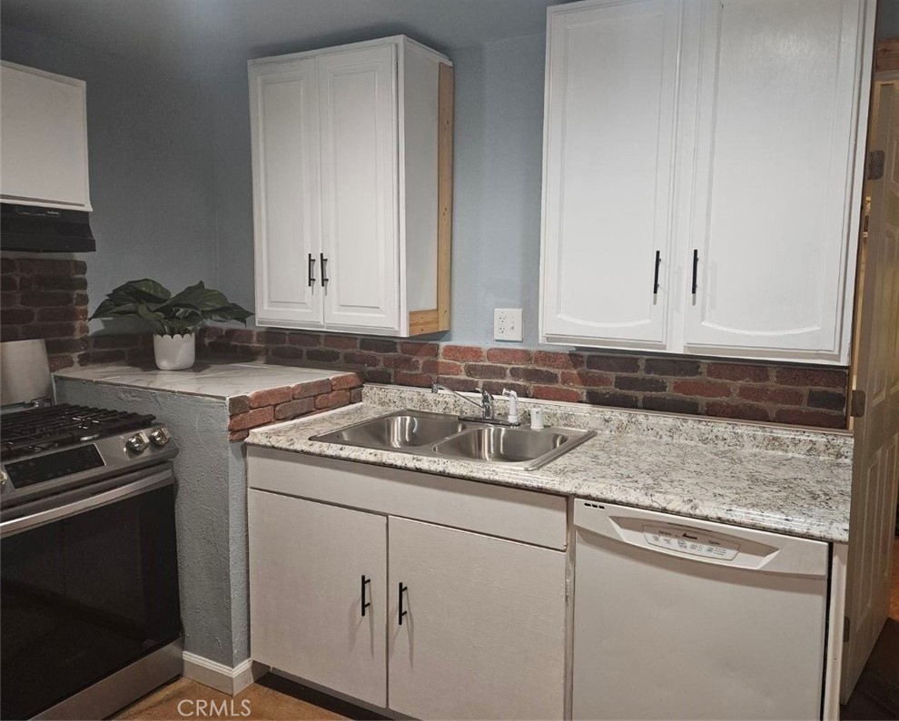 82414 3rd Street Trona, CA 93562 - Photo 11 of 13 a kitchen with a sink stove and cabinets