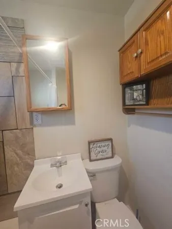a bathroom with a sink a toilet and vanity