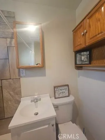 a bathroom with a sink a toilet and vanity