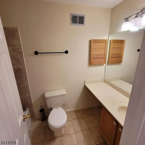 a bathroom with a sink a toilet and a shower