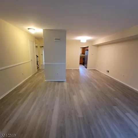 a view of a empty room with wooden floor