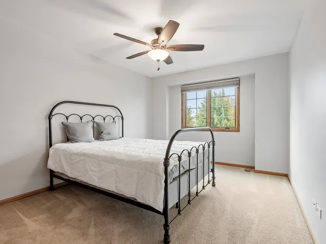 a bedroom with a bed and window