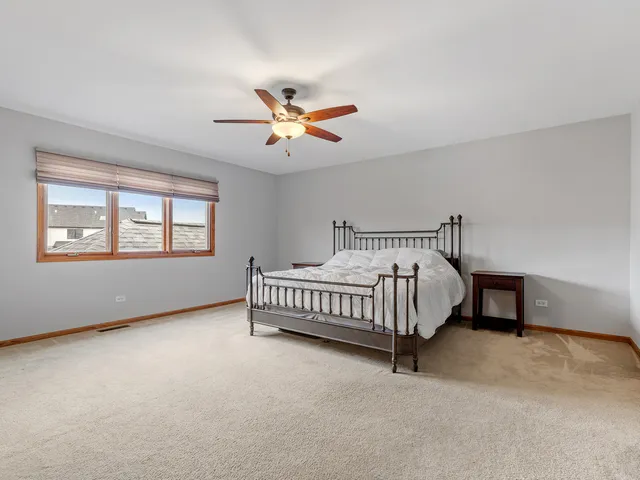 a spacious bedroom with a bed and a window