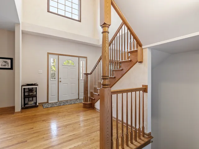 a view of an entryway with wooden floor and stairs