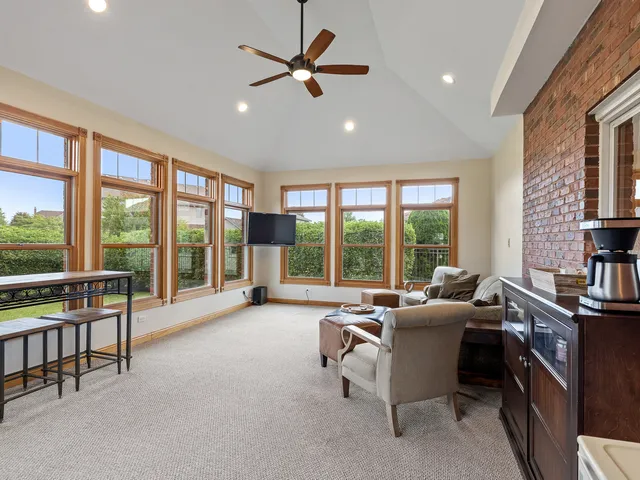 a living room with furniture and a floor to ceiling window