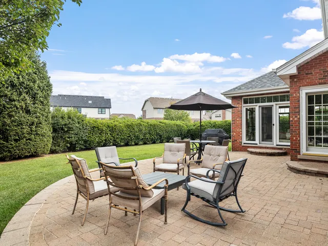 a view of a patio with furniture and a yard
