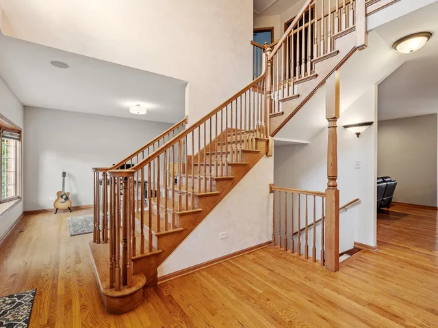 a view of entryway with wooden floor and stairs