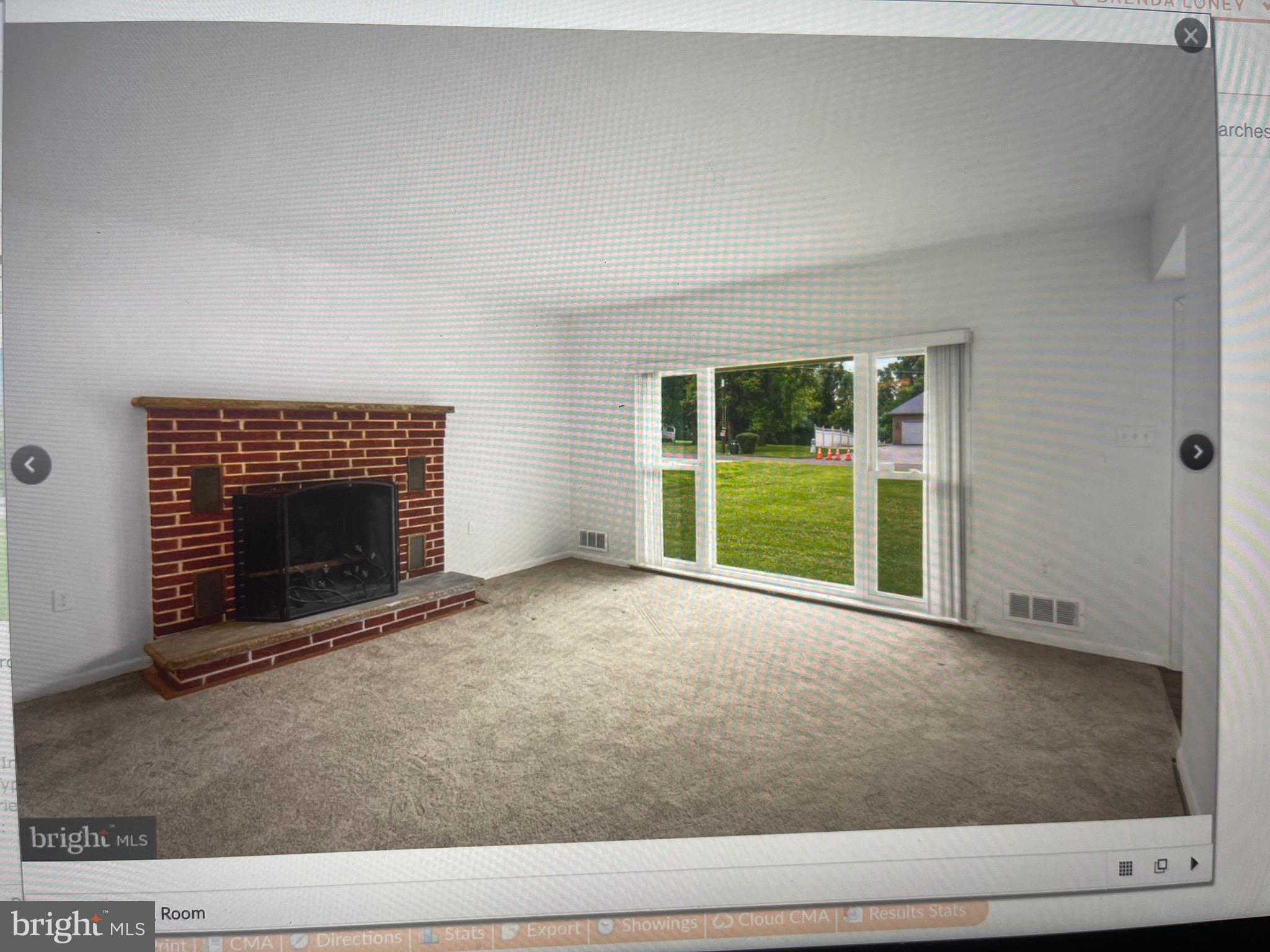 8608 Inwood Road Windsor Mill, MD 21244 - Photo 19 of 20 a view of an empty room with a fireplace and a window
