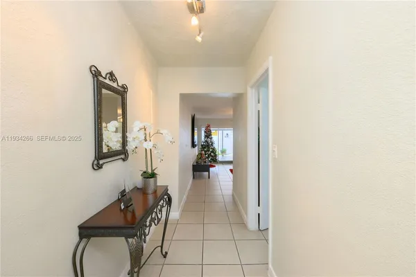 a view of a hallway with livingroom and furniture