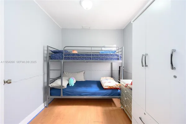 a bedroom with a bed and a potted plant