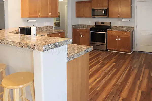 a kitchen with a refrigerator stove and a sink