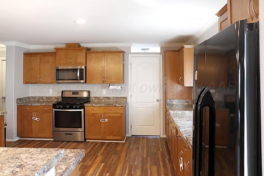 735 Wagon Mound Highway Other - Not In List, NM 87743 - Photo 14 of 39 a kitchen with a refrigerator stove and a sink