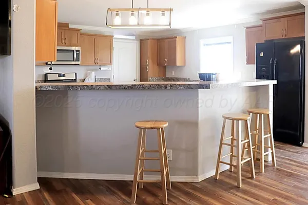 a kitchen with granite countertop cabinets stainless steel appliances a sink and a counter top space