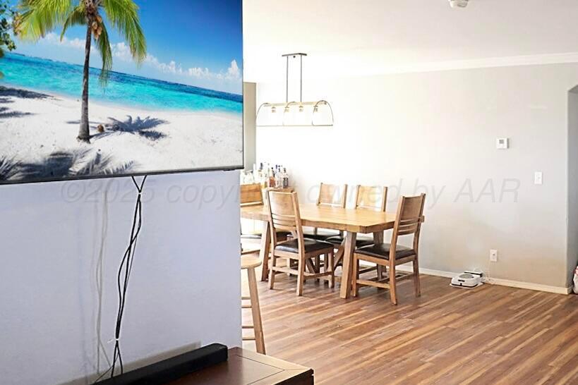 735 Wagon Mound Highway Other - Not In List, NM 87743 - Photo 22 of 39 a dining room with furniture and wooden floor