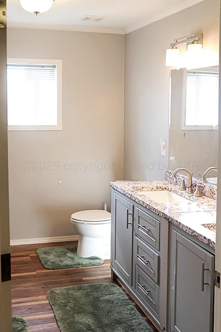735 Wagon Mound Highway Other - Not In List, NM 87743 - Photo 26 of 39 a bathroom with a granite countertop sink toilet and mirror