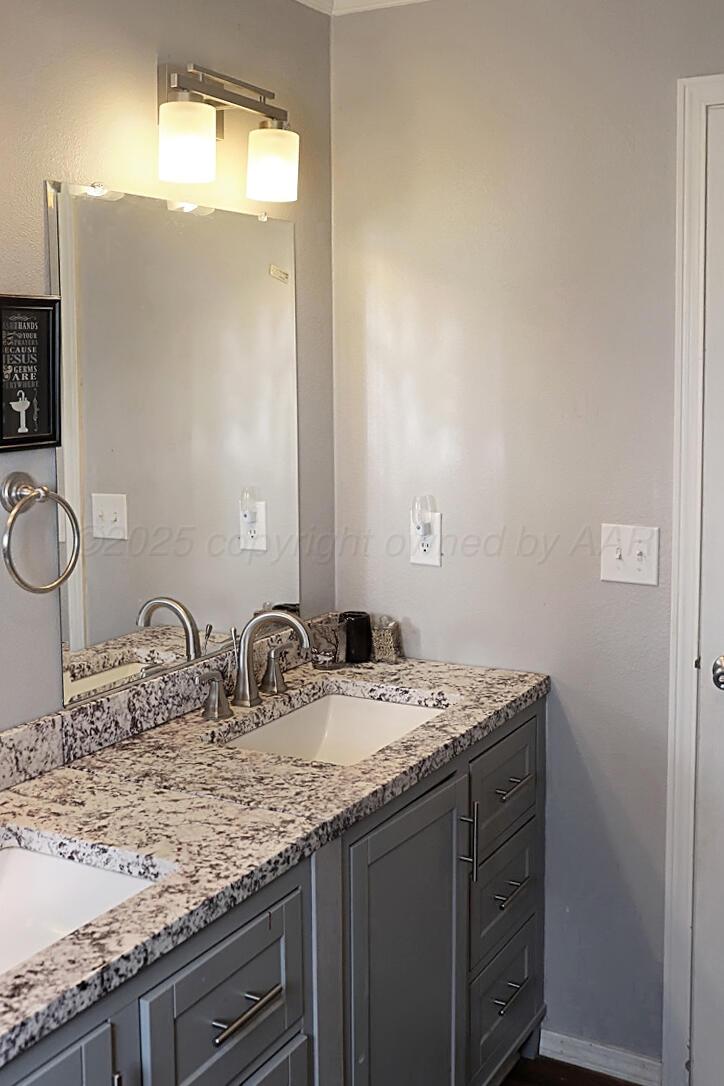 735 Wagon Mound Highway Other - Not In List, NM 87743 - Photo 27 of 39 a bathroom with a granite countertop sink and a mirror