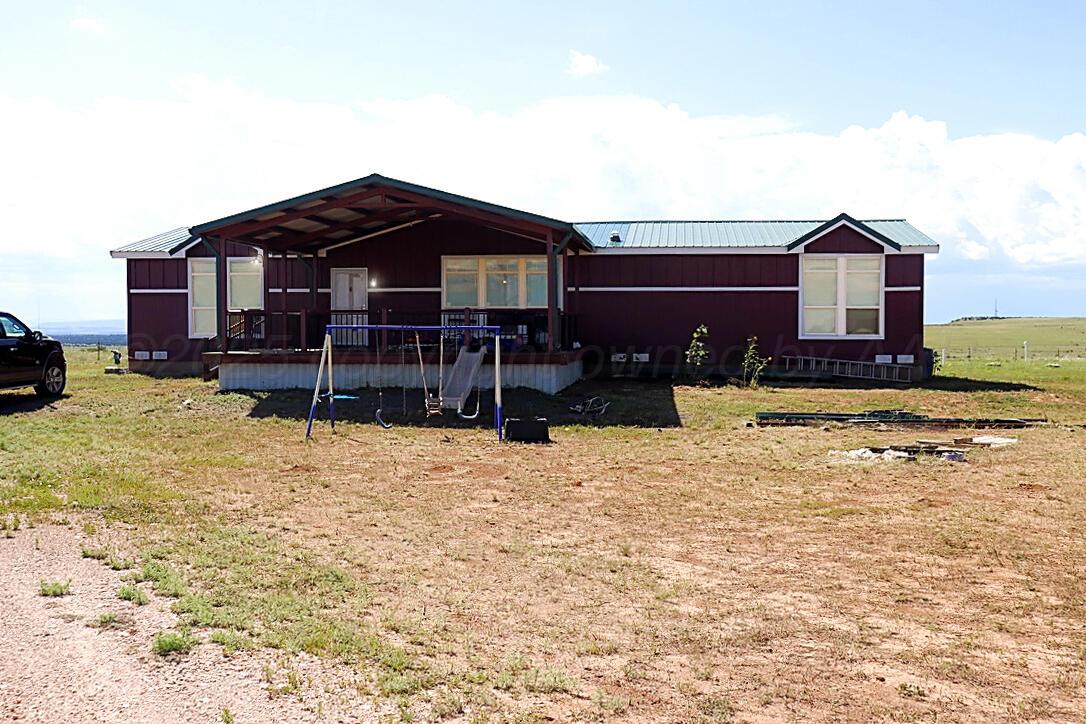 735 Wagon Mound Highway Other - Not In List, NM 87743 - Photo 4 of 39 a front view of a house with a yard