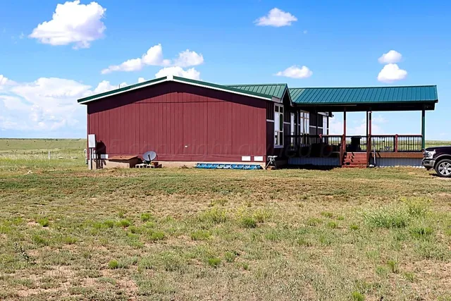 a view of a house with a yard covered in snow