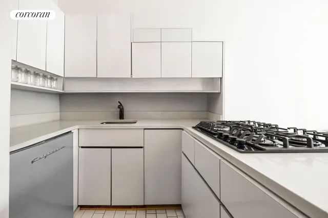 a living room with furniture wooden floor and kitchen view