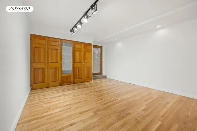 a view of a patio with couches and a fire pit and large trees