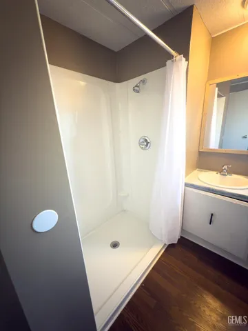 a bathroom with a shower and a sink