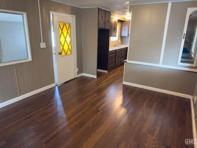 a view of a hallway with wooden floors and glass door