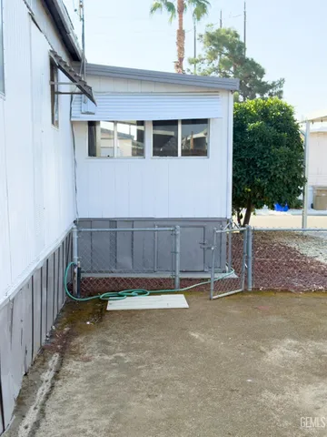 a view of a house with a big yard and sitting area