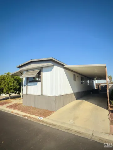 a view of a house with a backyard and a garage