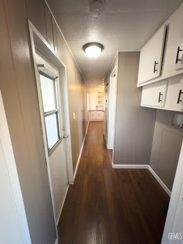 a view of a kitchen from a hallway