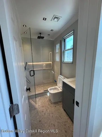 a bathroom with a toilet a sink and a shower