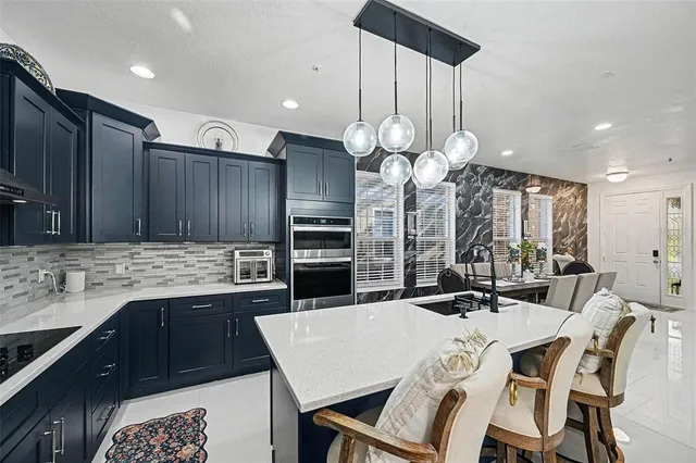a kitchen with a table chairs sink and cabinets
