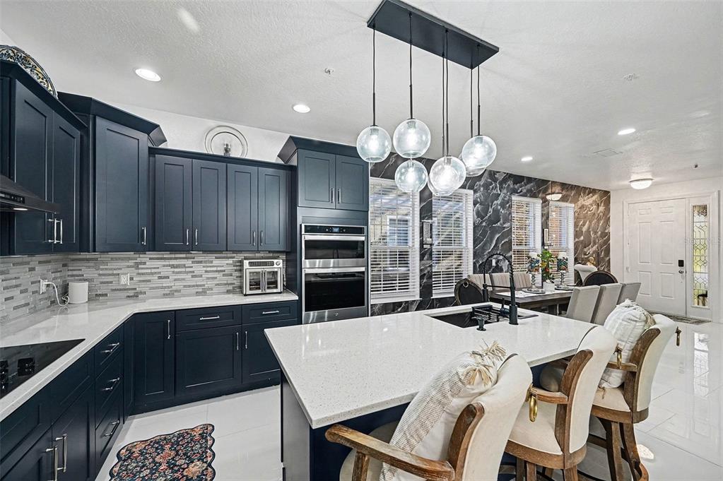 3565 Clay Brick Road, Unit 47 Harmony, FL 34773 - Photo 11 of 37 a kitchen with a table chairs sink and cabinets