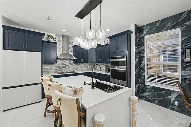 a kitchen with a table chairs and refrigerator