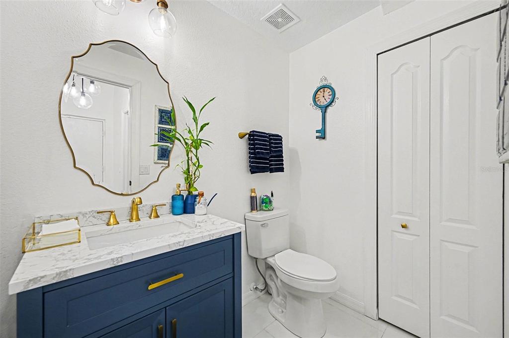 3565 Clay Brick Road, Unit 47 Harmony, FL 34773 - Photo 24 of 37 a bathroom with a granite countertop sink a toilet and a mirror