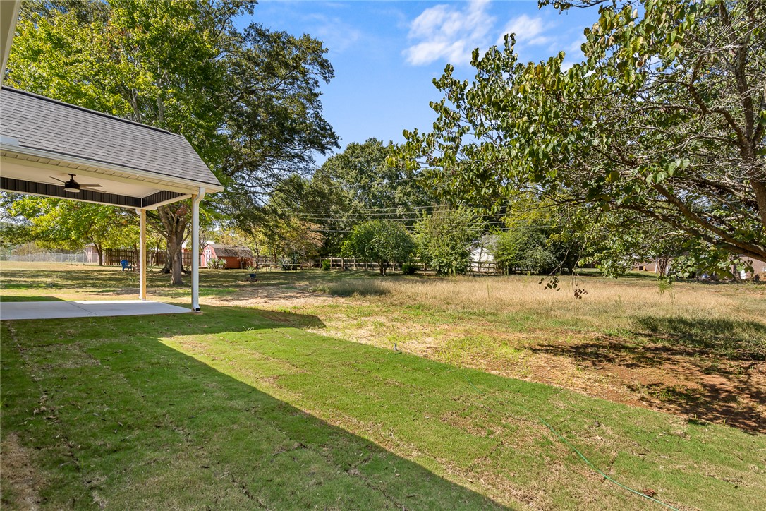 1507 Tindall Avenue Anderson, SC 29621 - Photo 31 of 38 Mature trees frame a spacious grassy lawn adjacent to a covered outdoor patio.