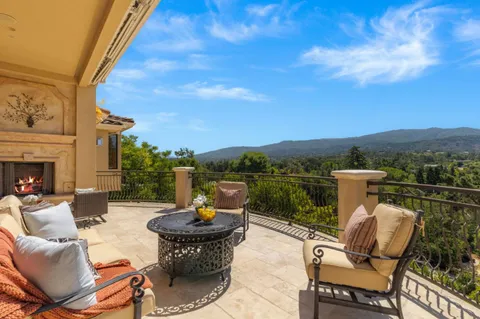 a view of a patio with couches chairs and a potted plant